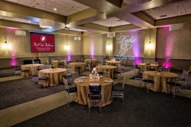 Clear Bamboo Chairs, Textured Table Overlay and Plate Chargers set for Special Celebration at the Red Oak Ballroom in Fort Worth, Sundance Square. Wider shot of Special Celebration at the Red Oak Ballroom in Fort Worth, Sundance Square featuring Clear Bamboo Chairs