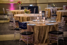 Clear Bamboo Chairs, Textured Table Overlay and Plate Chargers set for Special Celebration at the Red Oak Ballroom in Fort Worth, Sundance Square. Special Celebration at the Red Oak Ballroom in Fort Worth, Sundance Square featuring Clear Bamboo Chairs
