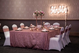 Ornately decorated Wedding at the Red Oak Ballroom in Fort Worth, Sundance Square. Specialty table overlays, chair covers with ties, plate chargers, and custom centerpieces Ornately decorated Head Table at the Red Oak Ballroom in Fort Worth, Sundance Square