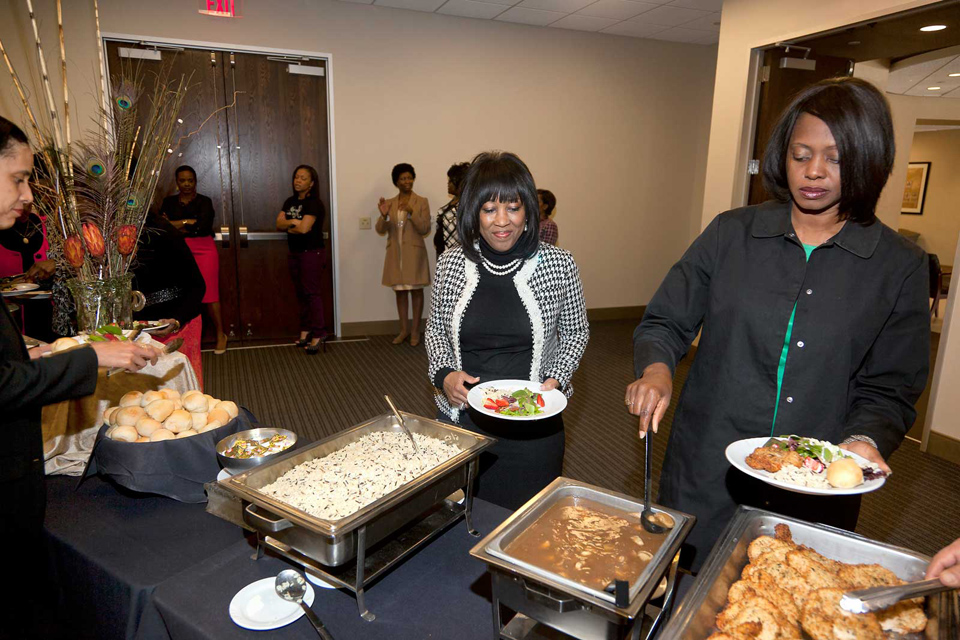 Attendees serving themselves lunch, at the Norris Centers in Austin