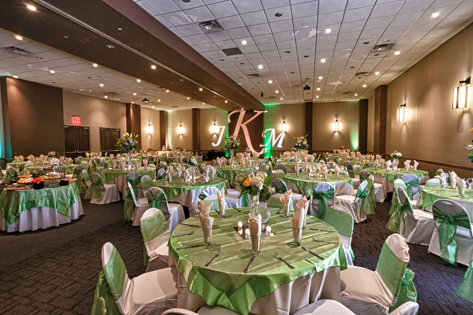 Green and White Room setup with Table Overlays, chair covers and ties , Wedding at the Red Oak Ballroom in Austin