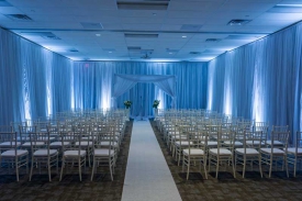 Wedding Ceremony Room set with Perimeter Drape, Altar, and Chiavari Chairs at the Red Oak Ballroom Houston/CityCentre